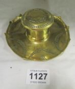 An Arts and Crafts brass inkwell