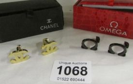 A pair of Chanel cuff links and a pair of Omega cuff links