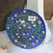 A floral decorated plate with flower marking on reverse