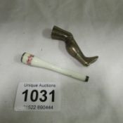 A silver & enamelled cigarette holder and bronze 'leg' pipe tamper