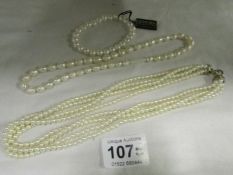 A 4 strand pearl necklace with silver clasp and a pearl necklace and bracelet