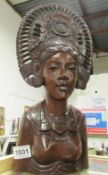 A carved wood female bust with headdress