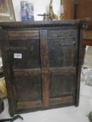 A small rustic corner cupboard