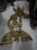 2 brass door knockers in the shape of birds