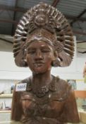 A carved wood female bust with headdress