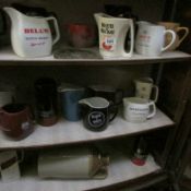 A large collection of Brewery advertising jugs