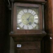 A Walnut long cased clock with brass dial