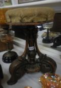 A Victorian mahogany revolving piano stool