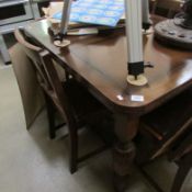 An oak draw leaf table and 4 chairs