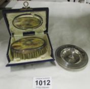 A small silver dish and a cased silver mounted brush set