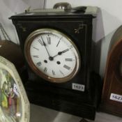 A Victorian black slate mantel clock