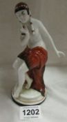 An Art Deco hard paste figure of a semi nude lady (18cm)