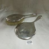 A silver backed hand mirror and hair brush