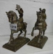 A pair of cast metal figures on horseback