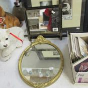 An oval gilt framed mirror and one other
