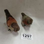 A pair of clockwork birds, possibly Schuco