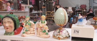 A Beswick character teapot, Doulton miniature figurine, bookends and an egg ornament