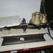 A set of scales with marble pan and weights