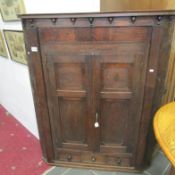 An oak corner cupboard