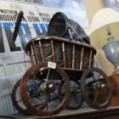 A Victorian style dolls pram with doll