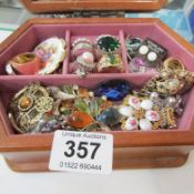 A jewellery box and brooches and rings