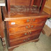 A small chest with drop down front and double height bottom drawer