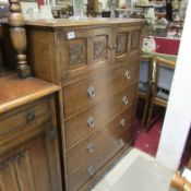 An oak 4 drawer chest with cupboard in top