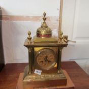 A brass mantel clock