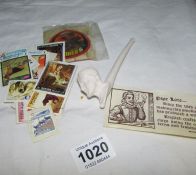 A clay pipe and quantity of loose stamps