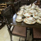 An oak draw leaf table and set of 6 chairs