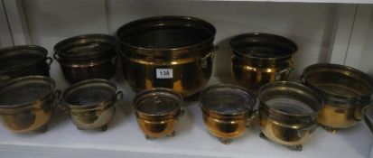 A mixed lot of brass footed plant pots