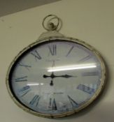 A French wall clock in the shape of a pocket watch