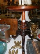 A mahogany tripod table on carved base