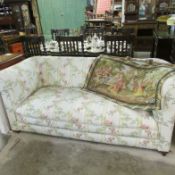 A floral covered Chesterfield sofa