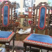 A pair of carved oak hall chairs