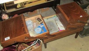 A concertina sewing box and contents