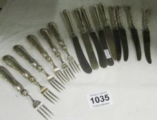 A quantity of silver handled knives and forks
