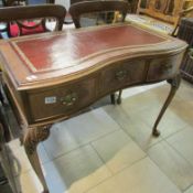 A leather topped writing table