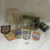 A quantity of cloth badges, military buttons etc