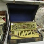 A cased piano accordian