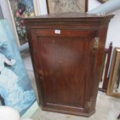 An oak corner cupboard