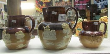 A set of 3 Doulton Stoneware graduated jugs