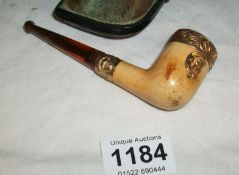 A unusual cased pipe with metal mounts