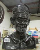 A carved ebony bust (chip to headdress)