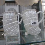 A pair of pearlware 'Nautilus' jugs