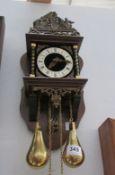 A brass and wood wall clock
