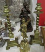 A pair of brass candlesticks and a brass figure