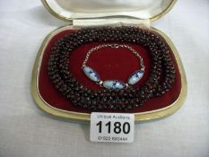 A glass bead necklace and a silver Delft bracelet