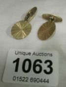 A pair of 9ct gold cuff links