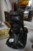 A black carved wood African bust